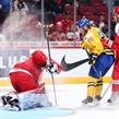 MONTREAL, CANADA - DECEMBER 26: Denmark's Lasse Petersen #30 makes the save while getting a face full of snow from Sweden's Sebastian Ohlsson #25 while Mathias Rondbjerg #7 looks on during preliminary round action at the 2017 IIHF World Junior Championship. (Photo by Andre Ringuette/HHOF-IIHF Images)

